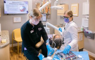 Two dental professionals working together during patient care in a well-organized dental practice