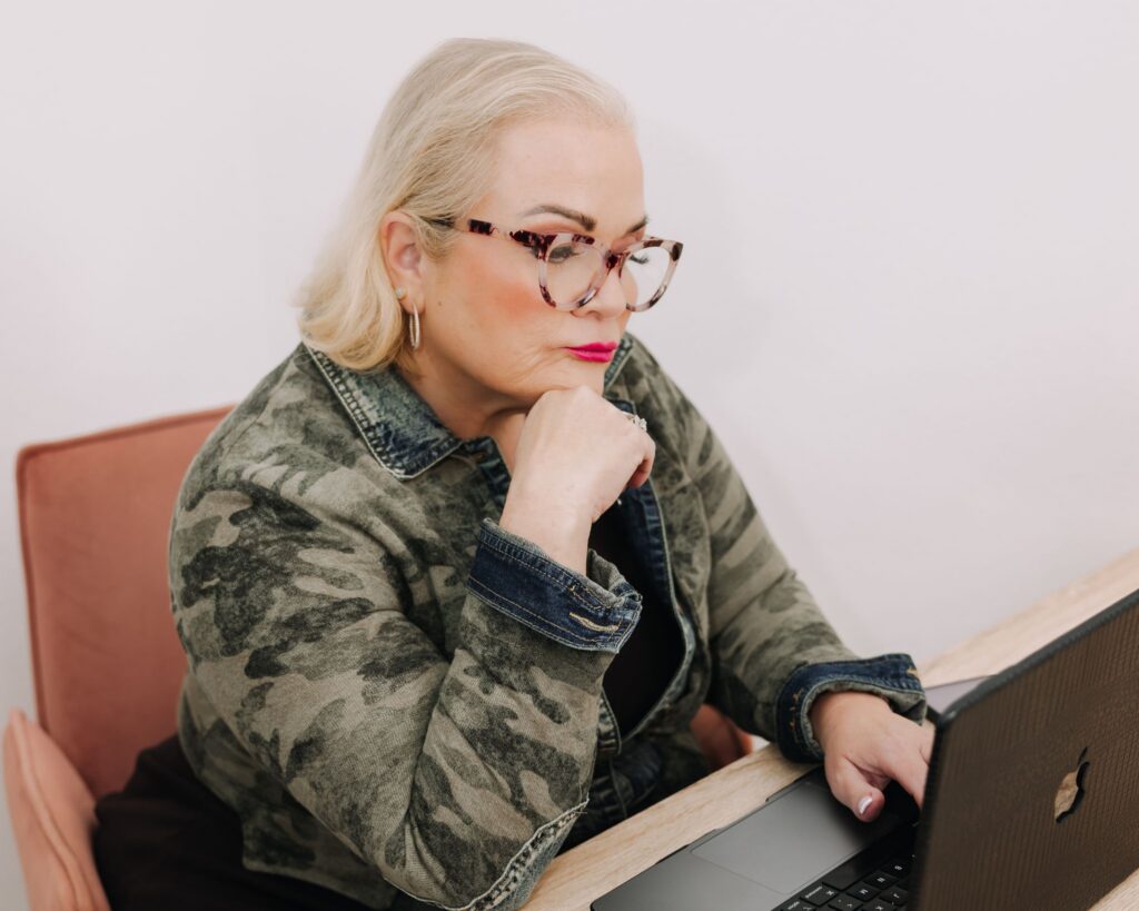 Dental practice coach reviewing systems and business strategy on a laptop
