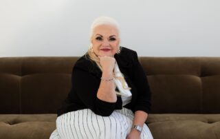 Dental practice leadership coach seated in a modern coaching setting, representing clarity, strategy, and owner growth.