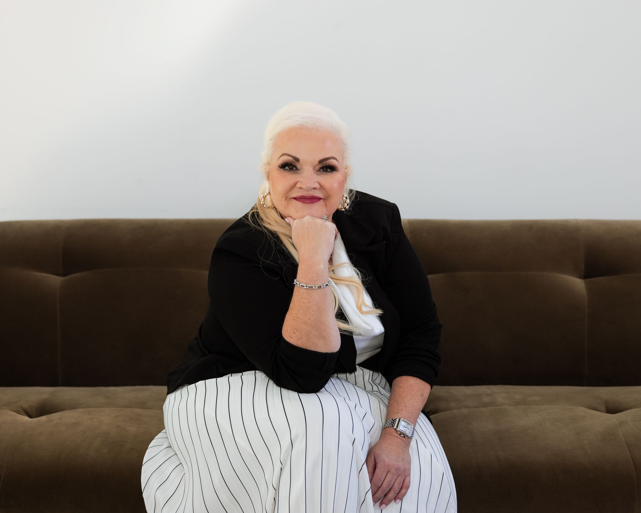 Dental practice leadership coach seated in a modern coaching setting, representing clarity, strategy, and owner growth.